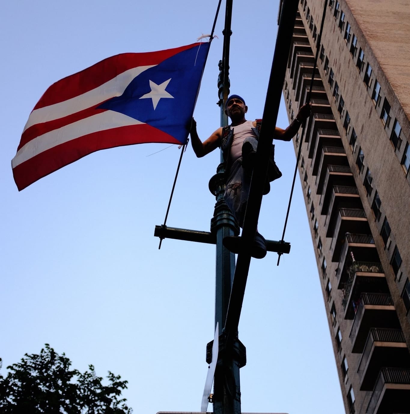 Chino Familia on a pole beside a large Puerto Rican flag on the Upper West Side.