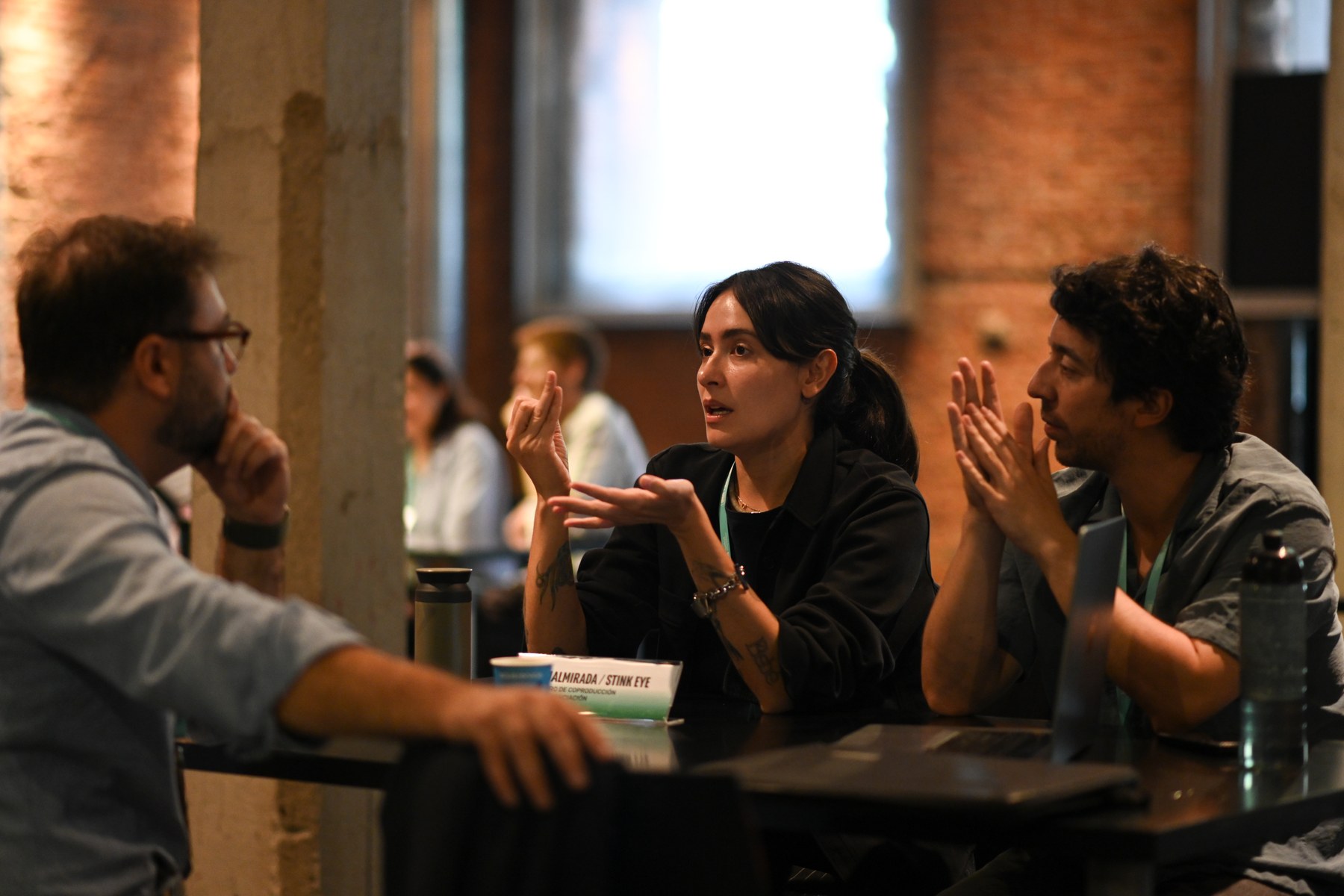 Three attendees talk around a table at the 2026 Iberseries & Platino Industria Co-Production Forum.